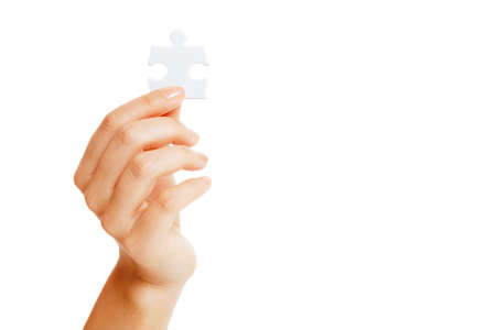 puzzle in hands isolated on white backgroundの写真素材