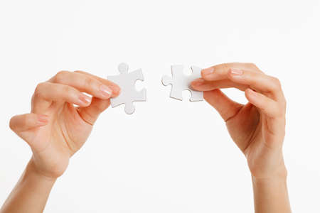 puzzle in hands isolated on white background