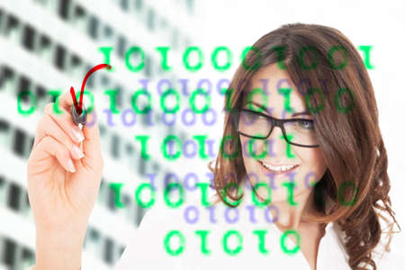 Business woman writing with marker pen on virtual screenの写真素材