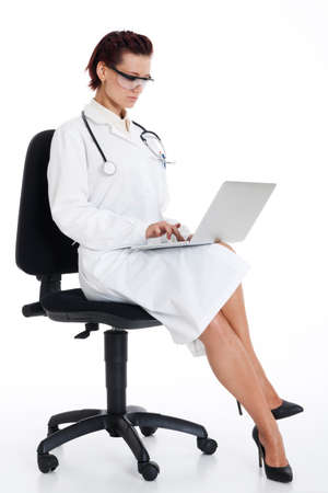 medical doctor woman with stethoscope and laptop. Isolated over white backgroundの写真素材