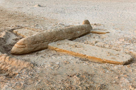 sand model Airplane landing on sunset tropical beach, Railay, Thailandの写真素材