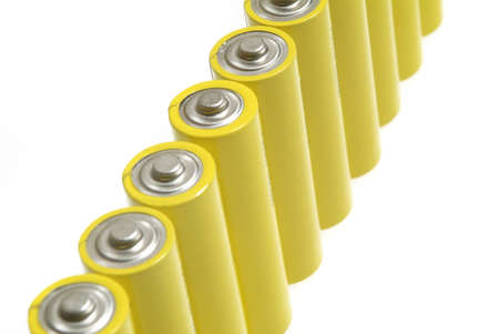 Yellow batteries over whiteの写真素材