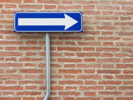 One way sign over a bricks wallの写真素材