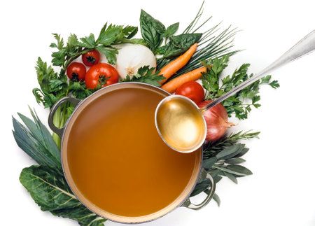 Cooking soup in a pot with vegetables on a white background.の写真素材