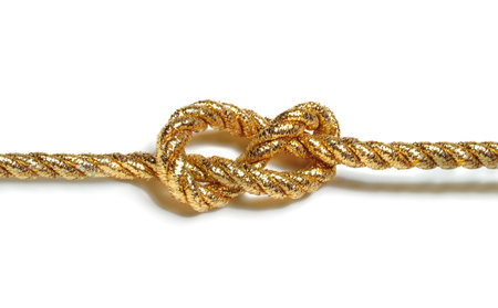 Rope knot isolated on white background. Golden rope with knot.
