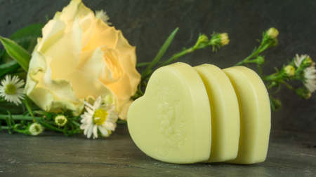 Yellow roses on a background of schifer with chocolate heartsの写真素材