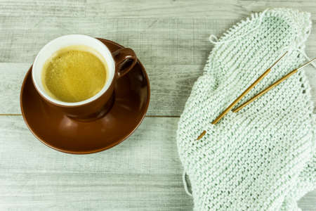 Wool ball with a cup of coffee and needlesの写真素材