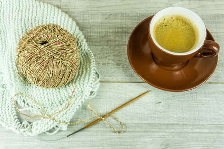 Wool ball with a cup of coffee and needlesの写真素材