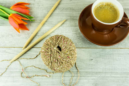 Wool ball with a cup of coffee and needlesの写真素材
