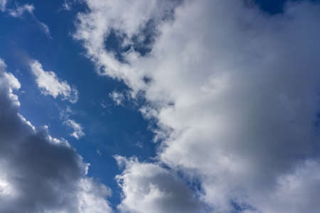 Blue sky with dark clouds as backgroundの写真素材