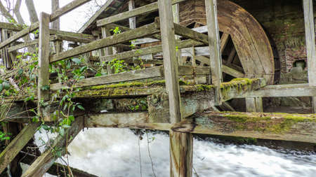 Old rustic water mill with a small streamの写真素材