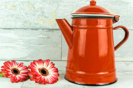 Gerbera in two colors with coffee can on a rustic wooden tableの写真素材