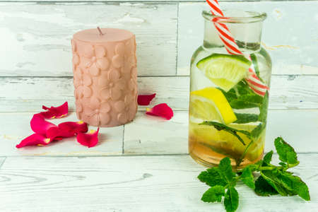 Red roses with a bio lemonade on a wooden tableの写真素材