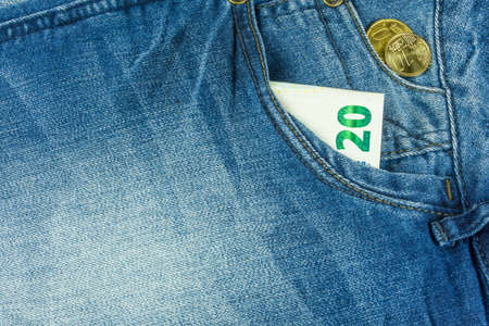 Jeans in blue with money in pocketの写真素材