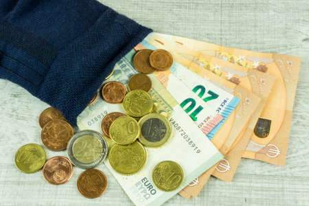 Money socks as piggybank on a wooden tableの写真素材