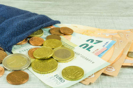 Money socks as piggybank on a wooden tableの写真素材