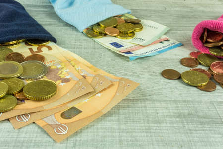Money socks as piggybank on a wooden tableの写真素材