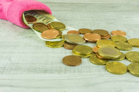 Money socks as piggybank on a wooden tableの写真素材