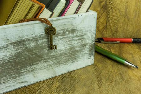 Many books in a wooden box on a rustic undergroundの写真素材