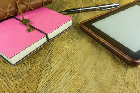 Notebooks in different colors with one ebook readerの写真素材