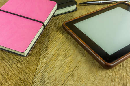 Notebooks in different colors with one ebook readerの写真素材