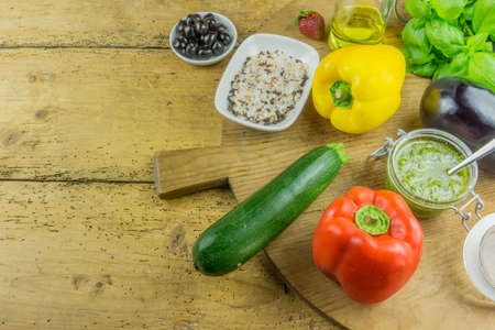 Fresh vegetable with pesto and herbal salt on a cutting board of woodの写真素材