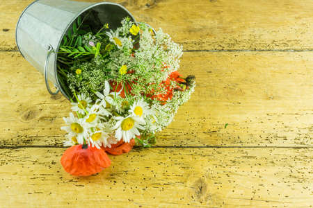 Colorful flowers summer bouquet on a wooden tableの写真素材