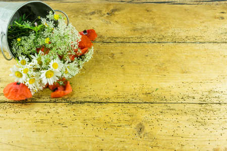 Colorful summer flowers on a rustic wooden backgroundの写真素材
