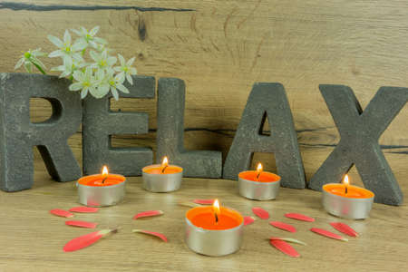 Rustic background of wood with candles and letters RELAXの写真素材