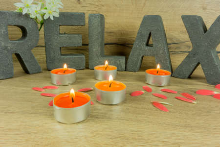 Rustic background of wood with candles and letters RELAXの写真素材