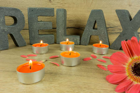 Rustic background of wood with candles and letters RELAXの写真素材
