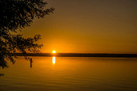 A small lake at sunrise and small wavesの写真素材