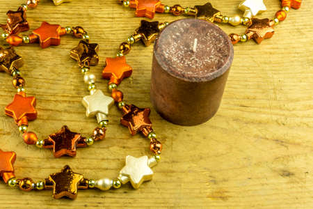 Christmas decoration with star garlands and candles on a rustic boardの写真素材