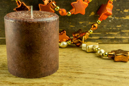 Christmas decoration with star garlands and candles on a rustic boardの写真素材