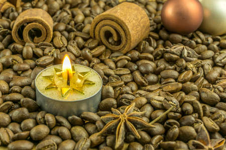Christmas decoration with coffee beans, christmas balls and candlesの写真素材