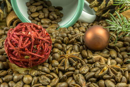 Christmas decoration with coffee beans, christmas balls and candlesの写真素材