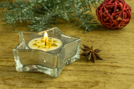 Christmas decoration with Christmas balls, aniseed, cinnamon and candlesの写真素材