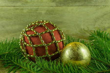 Christmas decoration - christmas balls and fir branch on a rustic boardの写真素材