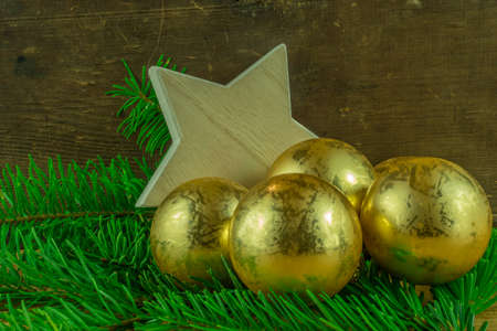 Christmas decoration - christmas balls and fir branch on a rustic boardの写真素材