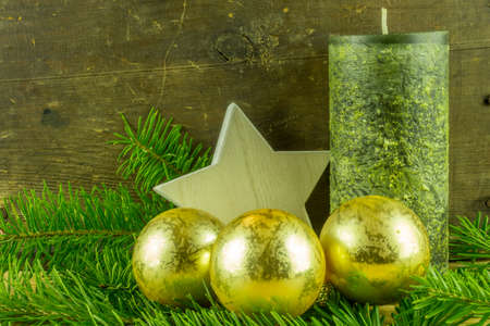 Christmas decoration - christmas balls and fir branch on a rustic boardの写真素材
