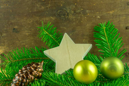 Christmas decoration - christmas balls and fir branch on a rustic boardの写真素材