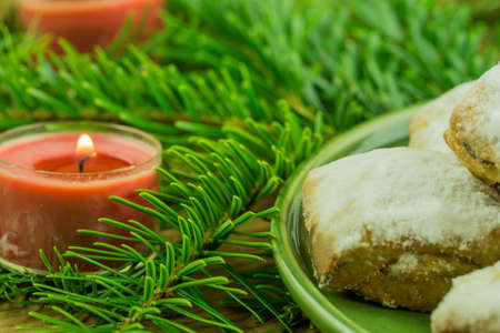 Christmas decoration - pine branch with red candles and Christmas biscuitsの写真素材