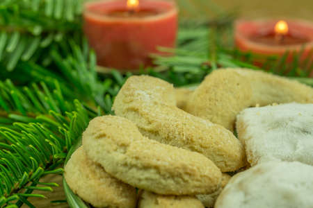 Christmas decoration - pine branch with red candles and Christmas biscuitsの写真素材