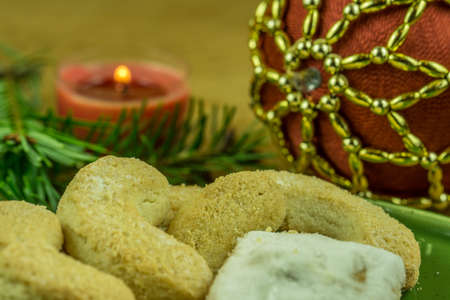 Christmas decoration - pine branch with red candles and Christmas biscuitsの写真素材