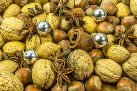 Christmas decoration from different varieties of nuts, cinnamon and anise starsの写真素材
