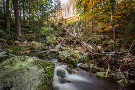 Mountain stream with waterfall in an autumn forest. time exposureの写真素材