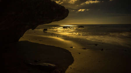 Coast of lava rock at sunset on the beachの写真素材