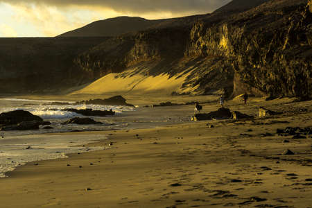 Coast of lava rock at sunset on the beachの写真素材