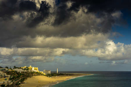 View over Jandia Fuerteventura with dark rain clouds and sunshineの写真素材