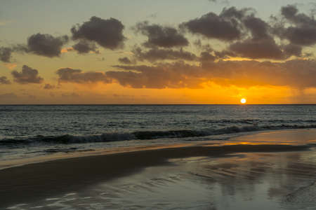 Sunset on the Atlantic coast with dark clouds and little wavesの写真素材